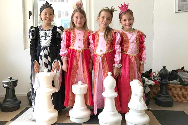 Little princesses dressed as chess pieces
