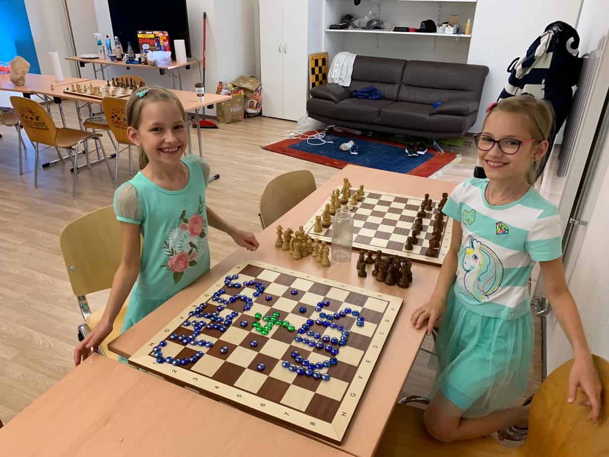 Two girls created the Chess4Kids sign with glass pieces