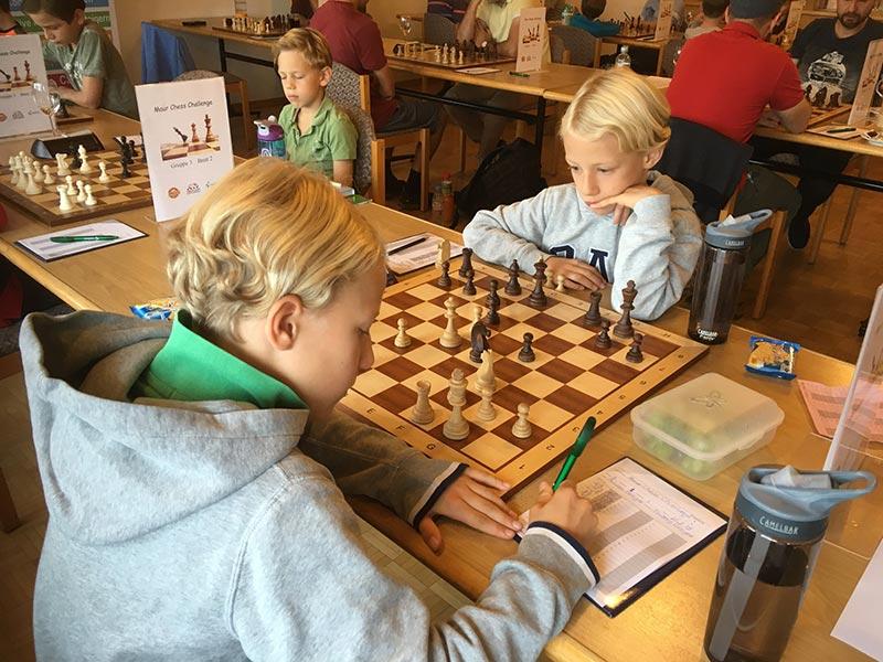 Kids playing a tournament chess game
