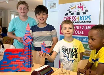 Children building a Lego tower at a chess course