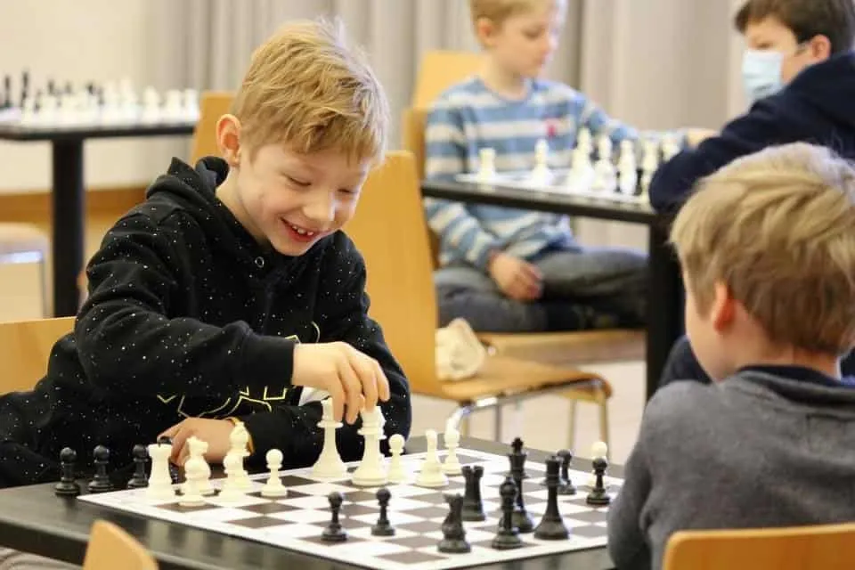 Two boys playing chess in a tournament