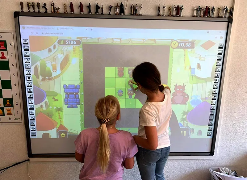 2 girls at the interactive chess screen